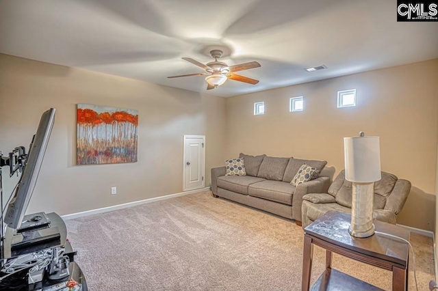 living room with ceiling fan and carpet