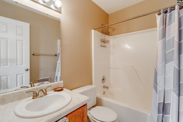 full bathroom with shower / bath combo with shower curtain, vanity, a textured ceiling, and toilet