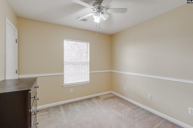 unfurnished room with light carpet, a textured ceiling, and ceiling fan