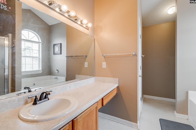 bathroom with vanity, a textured ceiling, a bathtub, and lofted ceiling