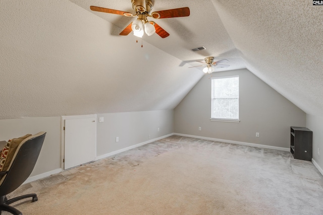 additional living space featuring a textured ceiling, light carpet, ceiling fan, and lofted ceiling