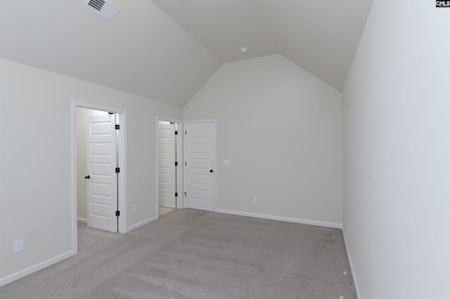 bonus room with light carpet and vaulted ceiling