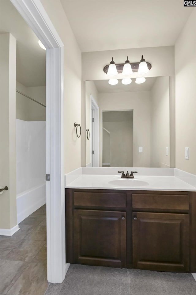 bathroom featuring a shower and vanity