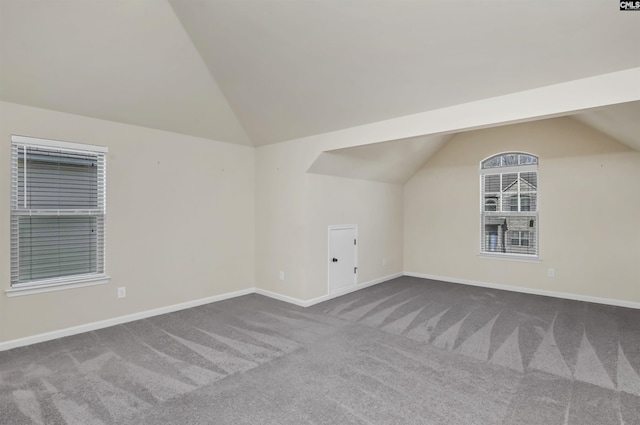 bonus room with carpet flooring and lofted ceiling