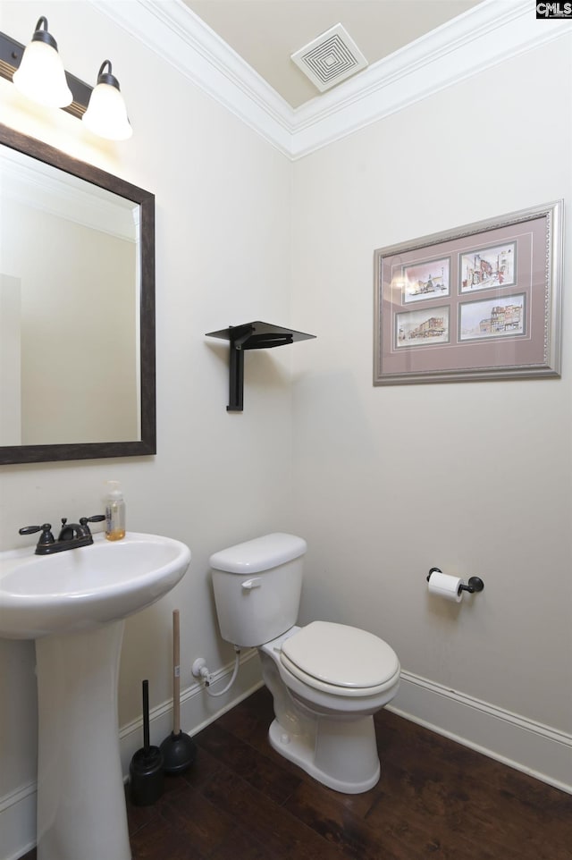 bathroom with sink, toilet, ornamental molding, and hardwood / wood-style flooring