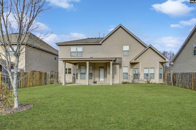 back of house with a lawn