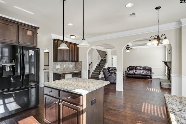 kitchen with black fridge with ice dispenser, dark brown cabinetry, and pendant lighting