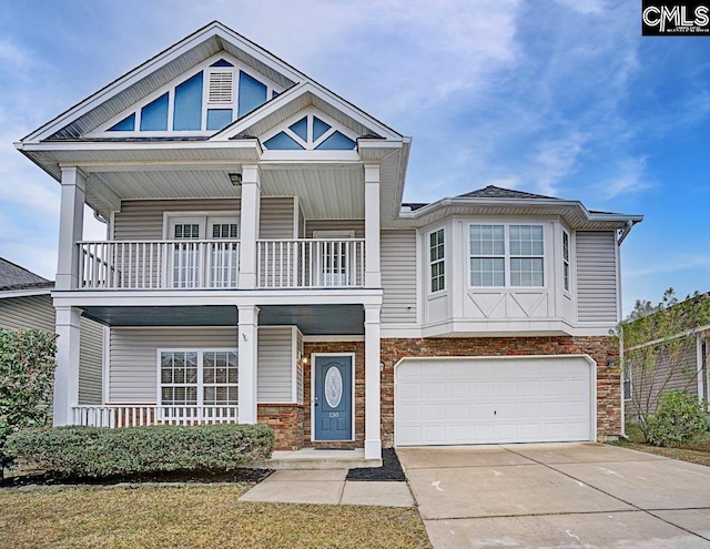 view of front of property with a porch and a garage