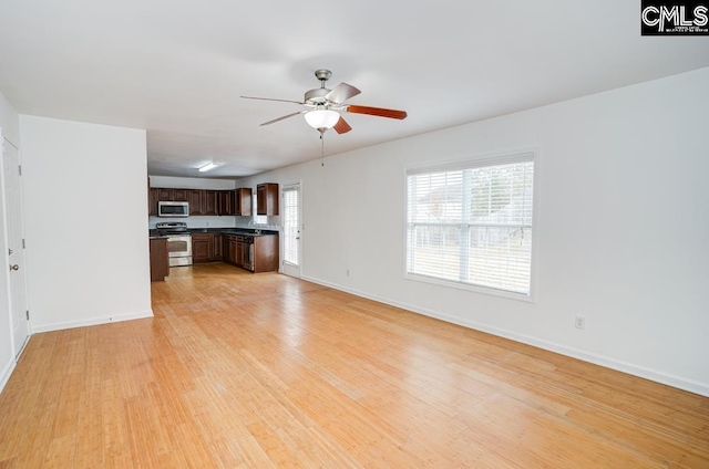 unfurnished living room featuring ceiling fan and light hardwood / wood-style floors