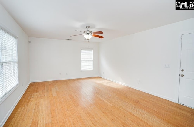 spare room featuring ceiling fan and light hardwood / wood-style flooring