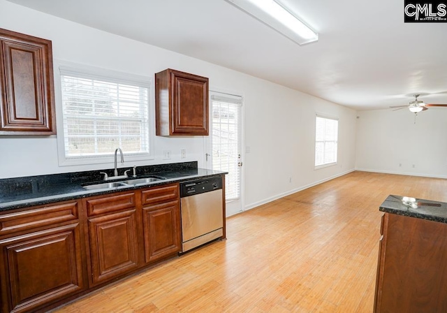 kitchen featuring dark stone counters, ceiling fan, sink, light hardwood / wood-style flooring, and dishwasher