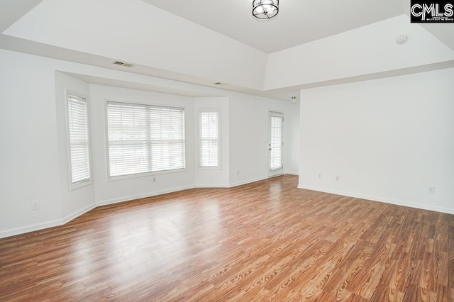 empty room with an inviting chandelier and light hardwood / wood-style flooring