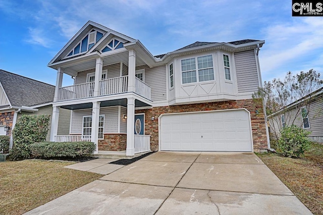 view of front of house featuring a porch, a garage, and a balcony