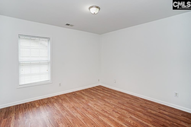 unfurnished room featuring hardwood / wood-style floors