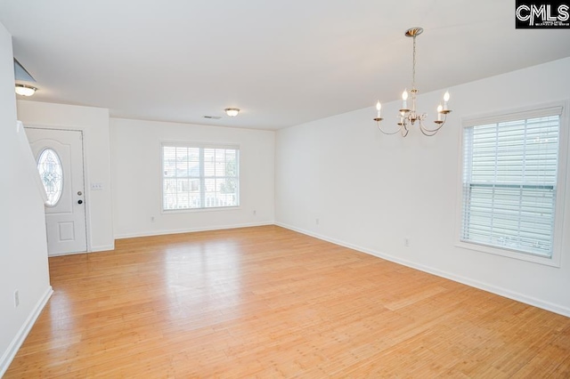 entrance foyer with a chandelier and light hardwood / wood-style floors