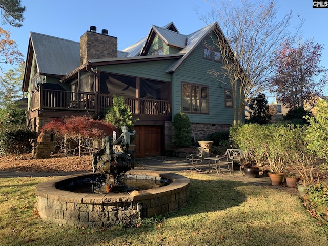 view of front of house featuring a sunroom and a front lawn