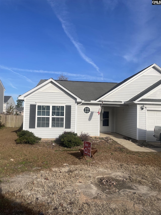 ranch-style house with fence and an attached garage