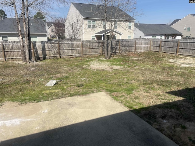 view of yard with a fenced backyard and a residential view