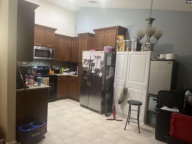 kitchen with stainless steel appliances, visible vents, high vaulted ceiling, and tasteful backsplash