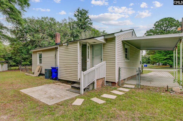 2432 Falcon Rd, North Charleston, SC 29406 - view of property exterior featuring a carport, a gate, crawl space, fence, and a yard