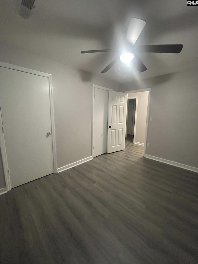 spare room featuring ceiling fan and dark hardwood / wood-style flooring