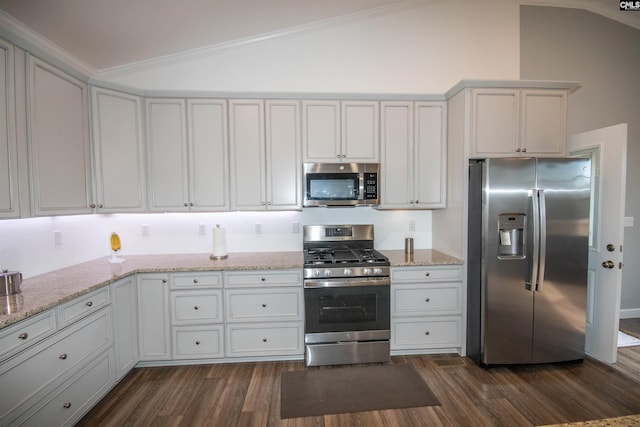 kitchen featuring white cabinets, dark hardwood / wood-style floors, lofted ceiling, and appliances with stainless steel finishes