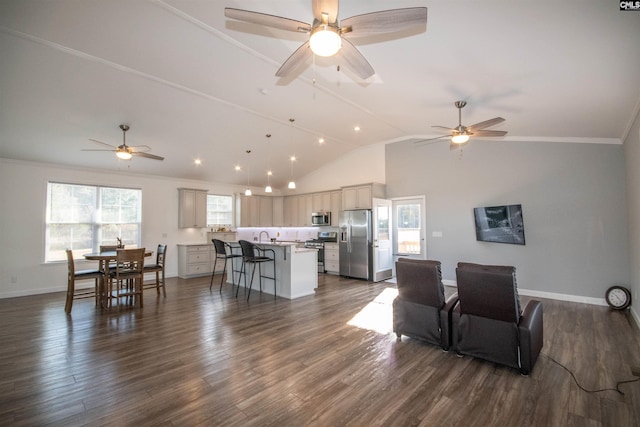 living room with dark hardwood / wood-style flooring, vaulted ceiling, and ornamental molding