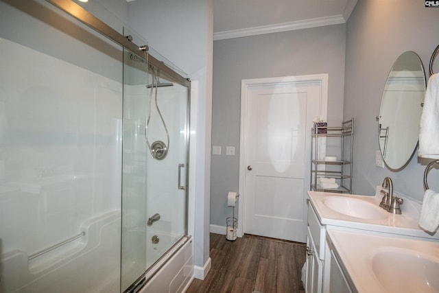 bathroom with shower / bath combination with glass door, wood-type flooring, vanity, and ornamental molding