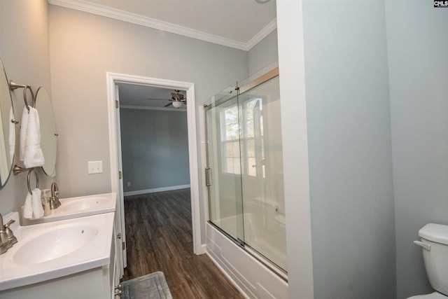 full bathroom featuring ceiling fan, crown molding, bath / shower combo with glass door, toilet, and hardwood / wood-style flooring