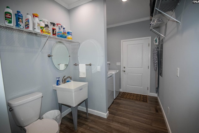 bathroom with washing machine and clothes dryer, crown molding, hardwood / wood-style floors, and toilet