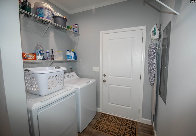 clothes washing area with washer and dryer, dark hardwood / wood-style flooring, and crown molding