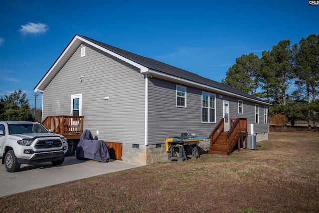 view of property exterior featuring a lawn and cooling unit