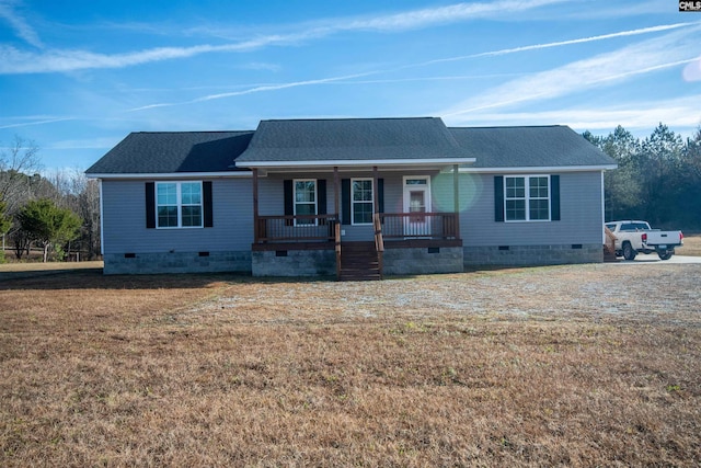 ranch-style house featuring covered porch and a front yard