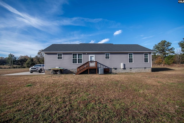 rear view of house featuring a yard