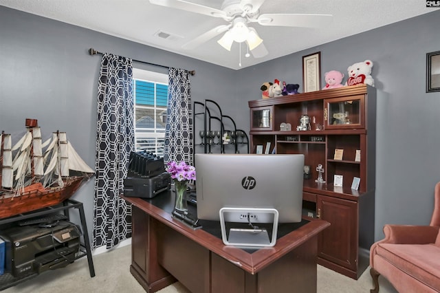 home office featuring light colored carpet and ceiling fan