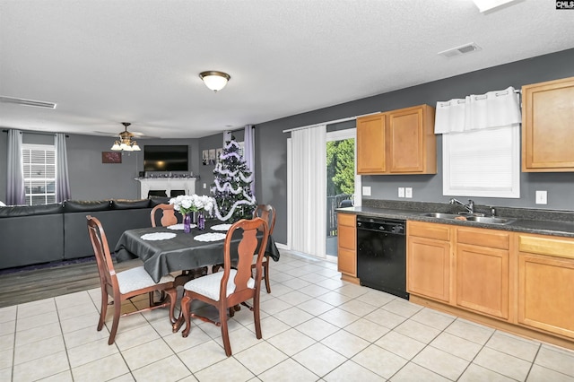 kitchen featuring ceiling fan, dishwasher, sink, a textured ceiling, and light tile patterned floors