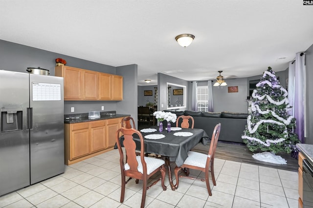 kitchen featuring stainless steel refrigerator with ice dispenser, light wood-type flooring, and ceiling fan