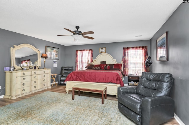 bedroom featuring hardwood / wood-style flooring and ceiling fan