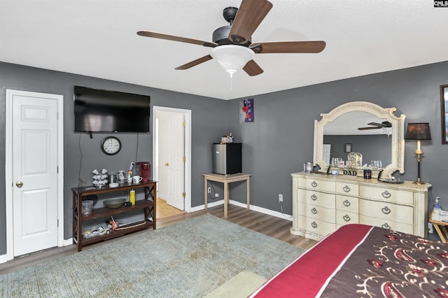 bedroom featuring ceiling fan and dark hardwood / wood-style floors