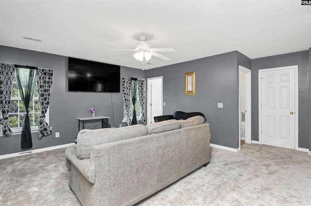 carpeted living room featuring ceiling fan