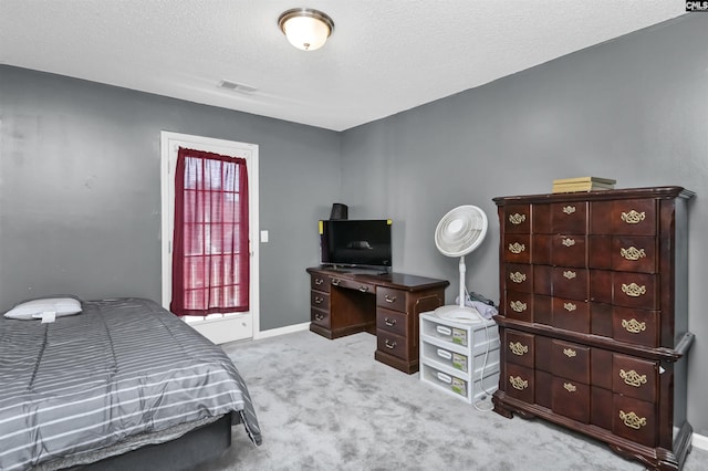 carpeted bedroom with a textured ceiling