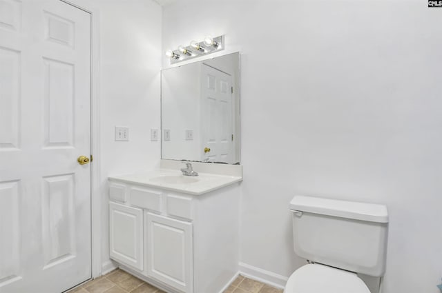 bathroom with tile patterned floors, vanity, and toilet