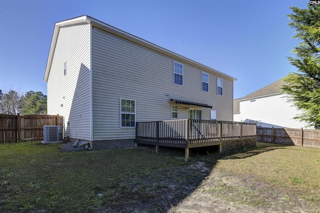 rear view of house featuring a yard, cooling unit, and a deck