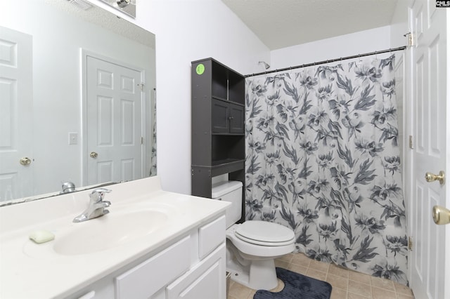 bathroom featuring a shower with curtain, vanity, a textured ceiling, tile patterned flooring, and toilet