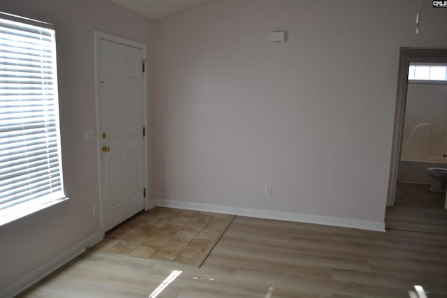 entryway with light hardwood / wood-style flooring and a healthy amount of sunlight