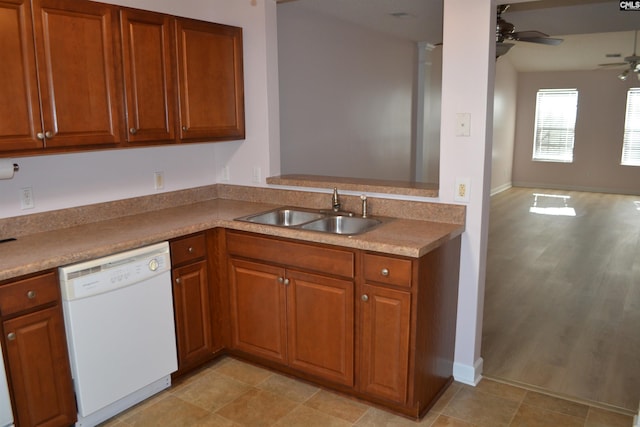 kitchen featuring dishwasher, light wood-type flooring, ceiling fan, and sink