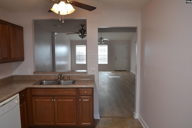 kitchen featuring dishwasher, ceiling fan, light wood-type flooring, and sink