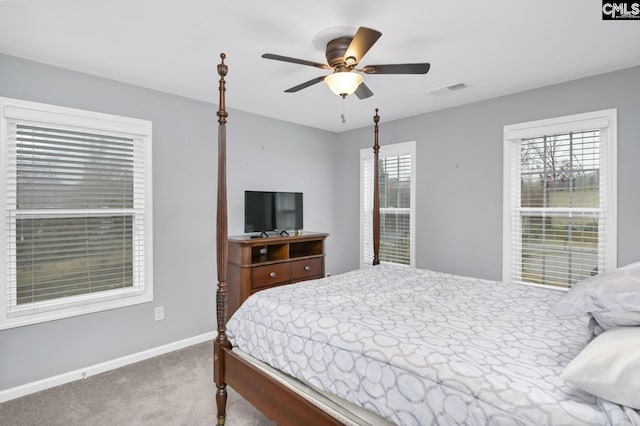 bedroom with multiple windows, carpet floors, and ceiling fan