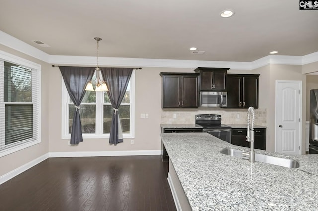 kitchen with sink, stainless steel appliances, tasteful backsplash, light stone counters, and dark hardwood / wood-style floors