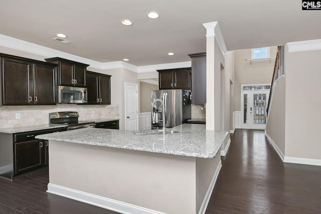 kitchen featuring light stone countertops, stainless steel appliances, dark hardwood / wood-style floors, and crown molding